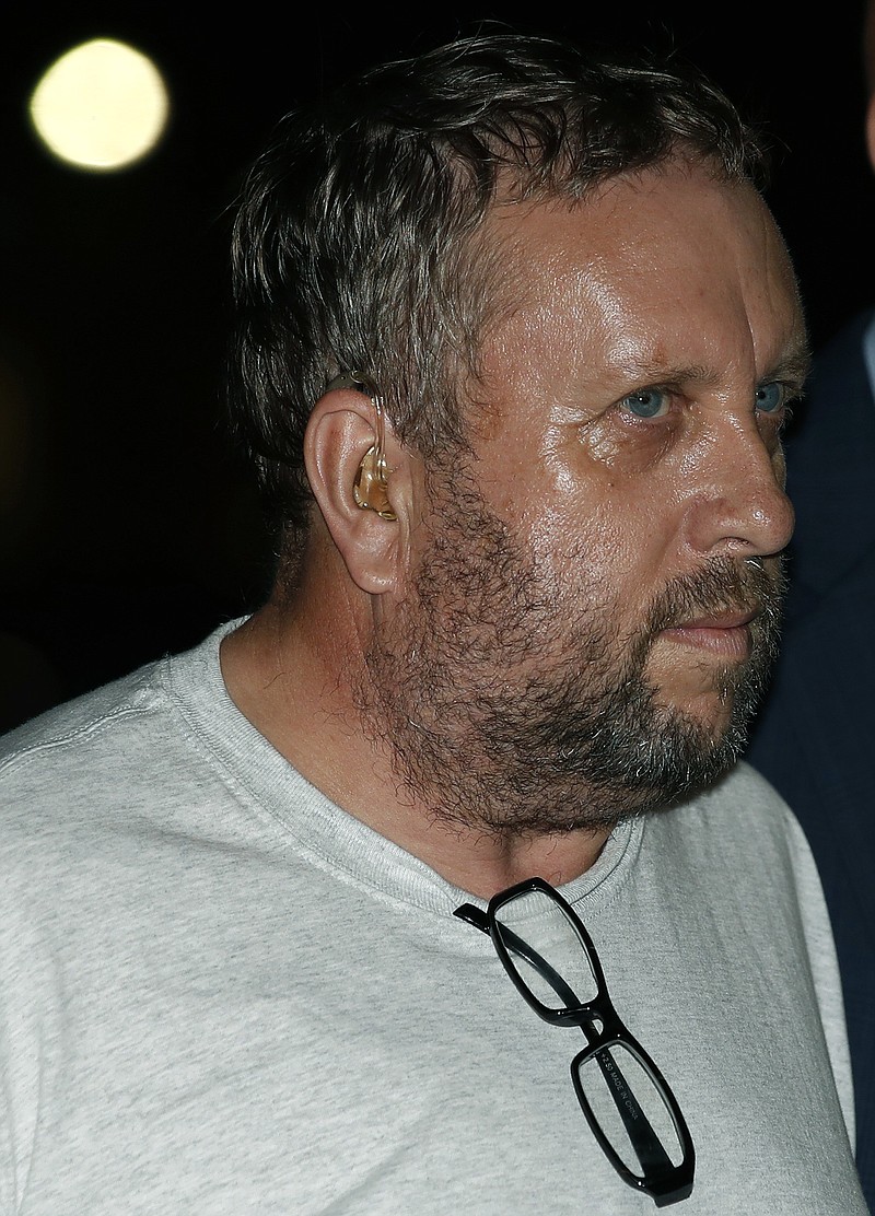 
              Andrew Warren arrives at a police station as he is escorted by Chicago police, Friday, Aug. 18, 2017, in Chicago. Warren, an Oxford University financial officer, and Wyndham Lathem, a Northwestern University professor, have been charged with first-degree murder in the death of Trenton James Cornell-Duranleau, a Michigan native who had been working in Chicago. Authorities say Cornell-Duranleau suffered more than 40 stab wounds to his upper body during the July attack in Lathem's high-rise Chicago condo. Lathem and Warren surrendered peacefully to police in California on Aug. 4 after an eight-day manhunt. (AP Photo/Jim Young, Pool)
            