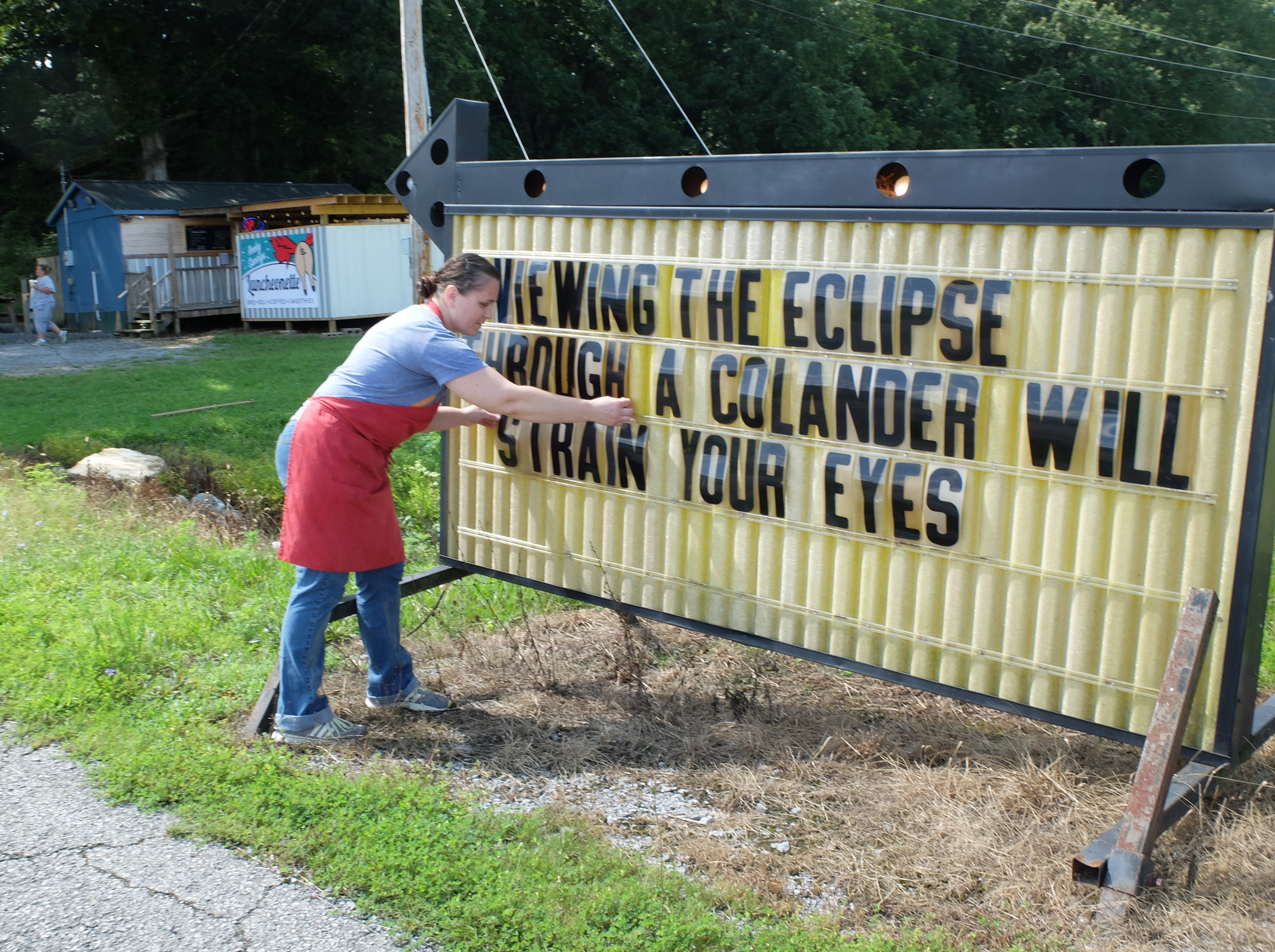 Eclipse Tip -- Daphnie Blake secures letters on the sign at Rocky Springs Luncheonette in Spring City. The witty sayings are a regular featured message outside the roadside restaurant at 26750 Rhea County Highway, just north of Spring City.