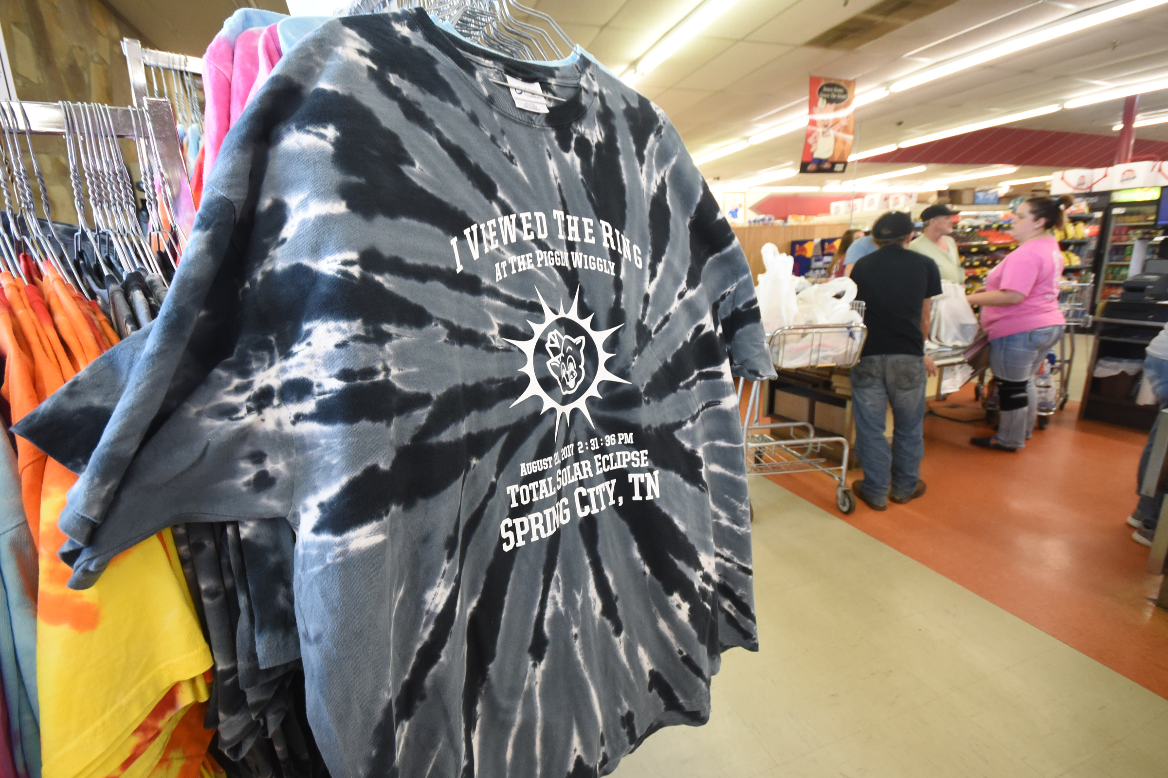 Tie-dyed T-shirts are on sale Friday at the Spring City Piggly Wiggly store as grocery sales are brisk before Monday's Great American Eclipse. The shirt says,