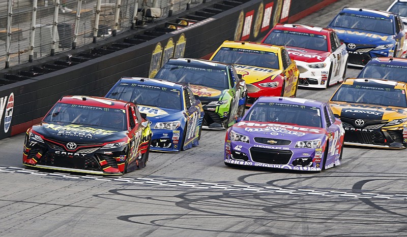 
              Erik Jones (77) leads Kyle Larson (42) and the rest of the field across the start line during the NASCAR Cup Series auto race, Saturday, Aug. 19, 2017 in Bristol, Tenn. (AP Photo/Wade Payne)
            