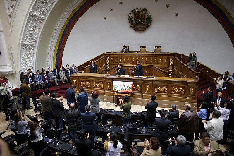 
              Members of the diplomatic corp, left , listen as lawmakers applaud during a session of Venezuela's National Assembly in Caracas, Venezuela, Saturday, Aug. 19, 2017. Venezuela's pro-government constitutional assembly took over the powers of the opposition-led congress Friday, dramatically escalating a standoff between President Nicolas Maduro and his political foes.(AP Photo/Ariana Cubillos)
            