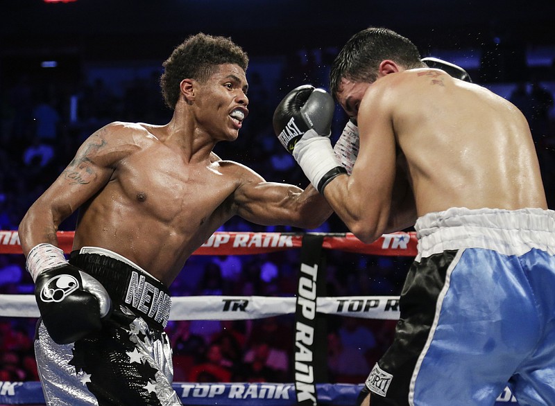 
              Shakur Stevenson, left, lands a punch on David Paz in the sixth round of a super featherweight bout in Lincoln, Neb., Saturday, Aug. 19, 2017. Stevenson won the fight by unanimous decision. (AP Photo/Nati Harnik)
            