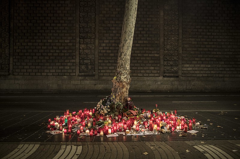 
              A memorial tribute of flowers, messages and candles to the van attack victims is seen on the historic Las Ramblas promenade, in Barcelona, Spain, Sunday Aug. 20, 2017. Authorities in Spain and France pressed the search Saturday for the supposed ringleader of an Islamic extremist cell that carried out vehicle attacks in Barcelona and a seaside resort, as the investigation focused on links among the Moroccan members and the house where they plotted the carnage.(AP Photo/Santi Palacios)
            