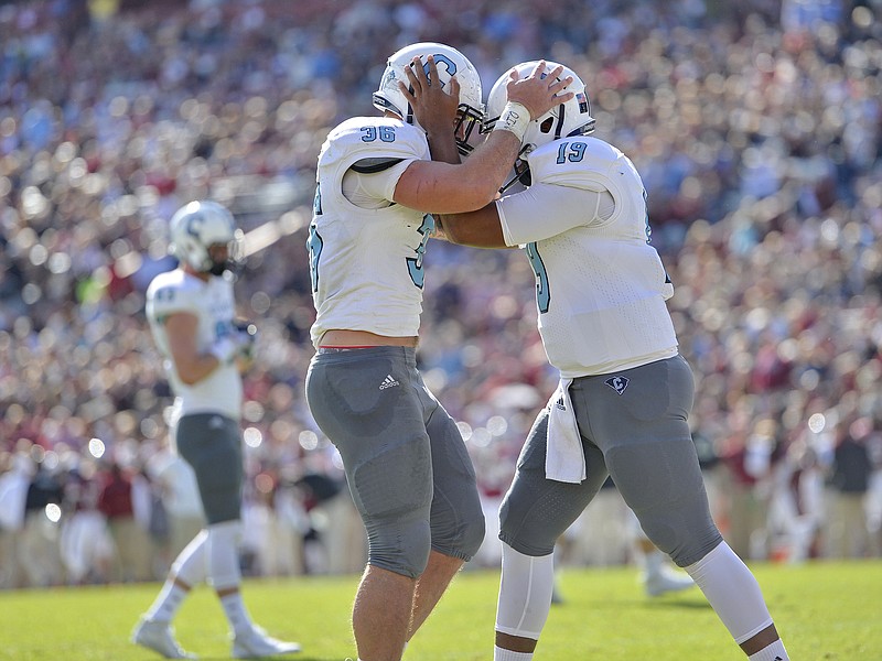 Citadel's Tyler Renew, left celebrates a touchdown with quarterback Dominique Allen during the first half of an NCAA college football game against South Carolina, Saturday, Nov. 21, 2015,  in Columbia,  S.C. (AP Photo/Richard Shiro)