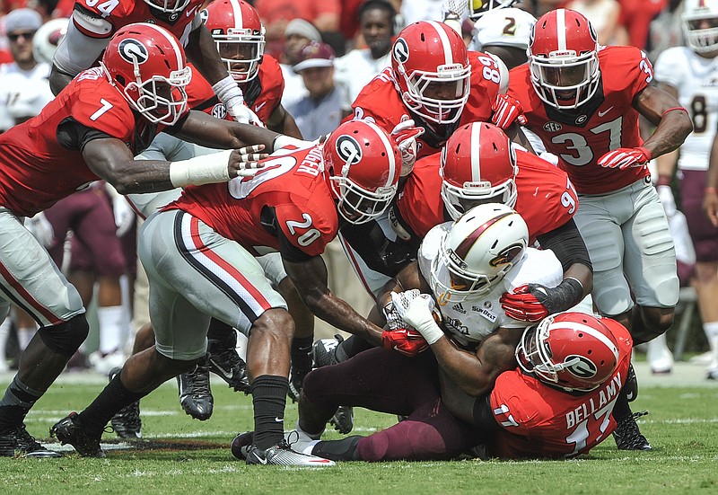 Georgia linebacker Davin Bellamy, at bottom of pile, and his teammates bring down Louisiana-Monroe running back DeVontae McNeal. Bellamy is expected to be one of the Bulldogs' biggest contributors this season.