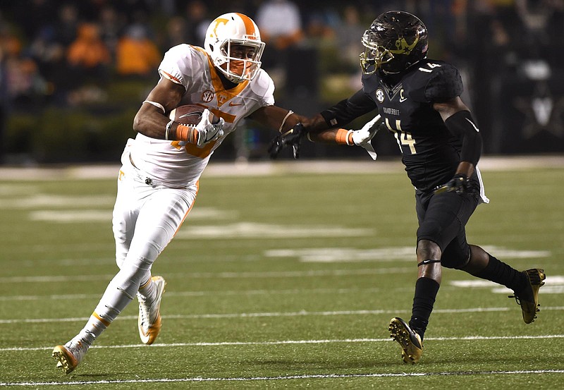 Tennessee's Jauan Jennings (15) attempts to stiff-arm Vanderbilt's Ryan White (14).  The Tennessee Volunteers visited the Vanderbilt Commodores in a cross-state rivalry at Dudley Stadium on November 26, 2016.  