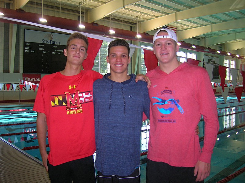 Team USA representative Trey Freeman, right, poses with Baylor teammates and Barbados swimmers Jack Kirby, left, and Luis Sebastian Weekes in advance of their trip to Indianapolis for the FINA World Junior Championships this week.