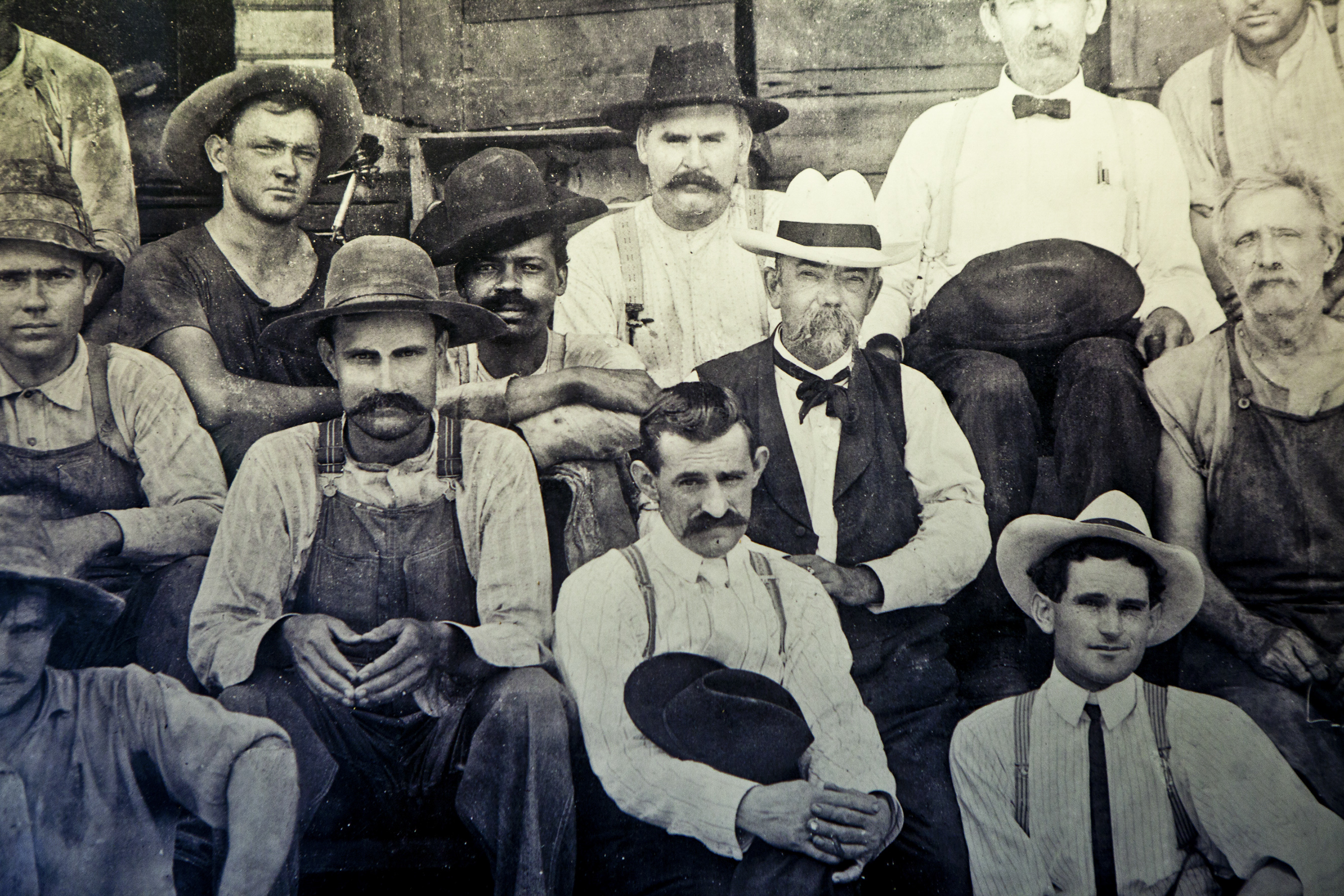 An undated photo from Jack Daniel's old office of Daniel, center in white hat, and an unidentified black man who may be the slave Nearest Green or one of his sons. Nearest Green taught Daniel how to make whiskey. (Handout via The New York Times) -- NO SALES; FOR EDITORIAL USE ONLY WITH STORY SLUGGED WHISKEY SLAVE BY RISEN FOR AUG. 15, 2017. ALL OTHER USE PROHIBITED.
