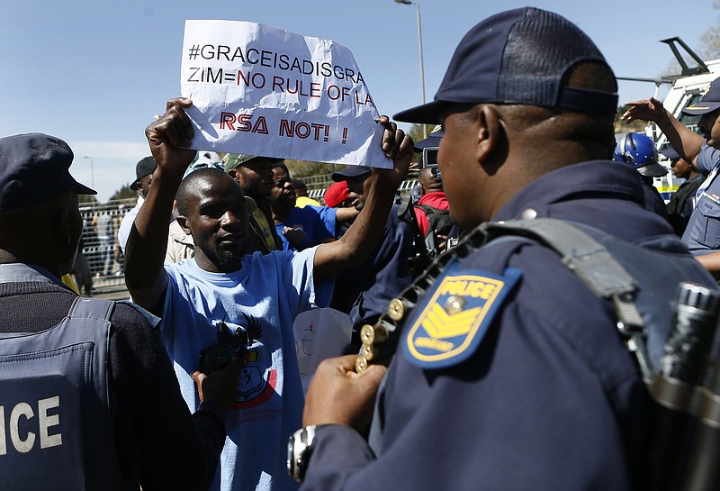 
              Anti-Mugabe demonstrators protest against Zimbabwean First Lady Grace Mugabe, in Pretoria, South Africa, Saturday, Aug. 19, 2017, as tensions rise over allegations that she assaulted a young model at a luxury hotel in Johannesburg last Sunday. South Africa's government says it has not yet decided to grant the Zimbabwe government's request for diplomatic immunity for Mugabe. (AP Photo)
            