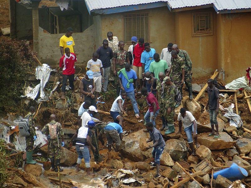 
              FILE- In this Tuesday, Aug.15, 2017 file photo, volunteers search for bodies from the scene of heavy flooding and mudslides in Regent, just outside of Sierra Leone's capital Freetown. Survivors picking through the debris of Sierra Leone's deadly mudslides are facing the reality that most, if not all, of the estimated 600 people missing are dead. (AP Photo/ Manika Kamara, File)
            