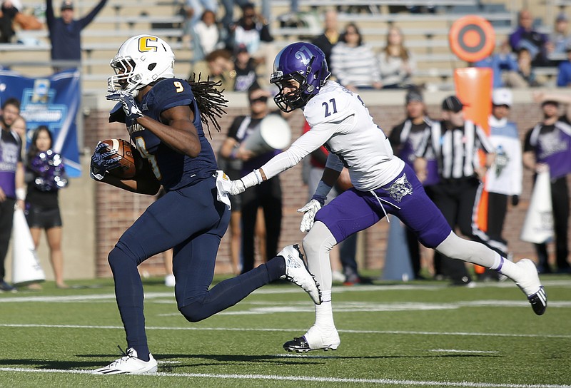 UTC wide receiver Alphonso Stewart runs into the end zone ahead of Weber State cornerback Dre Snowden during the Mocs' first-round FCS football playoff game against Weber State at Finely Stadium on Saturday, Nov. 26, 2016, in Chattanooga, Tenn. UTC won 45-14.