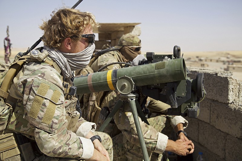 
              Belgian special forces soldiers sit on a rooftop with a guided-missile launcher, a few miles from the frontline, in the village of Abu Ghaddur, east of Tal Afar, Iraq, Sunday, Aug. 20, 2017. Iraqi forces have launched a multi-pronged assault to retake the town of Tal Afar, west of Mosul, marking the next phase in the country's war on the Islamic State group. Tal Afar and the surrounding area is one of the last pockets of IS-held territory in Iraq after victory was declared in July in Mosul, the country's second-largest city. (AP Photo/Balint Szlanko)
            