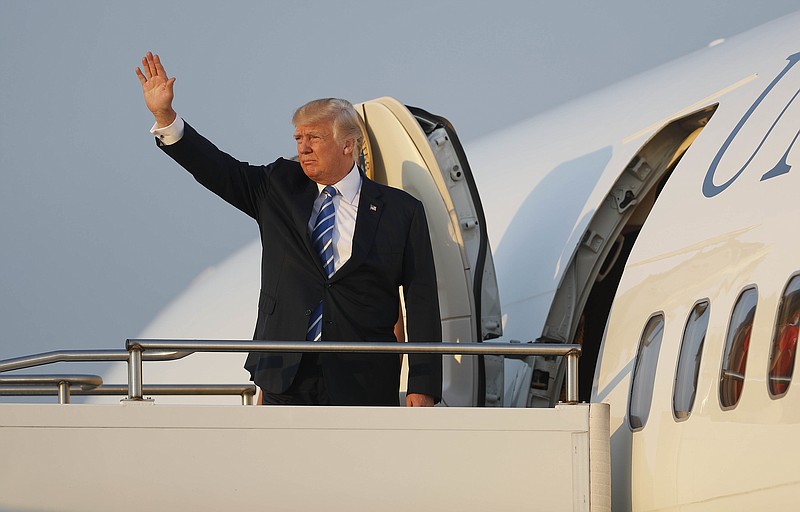 
              President Donald Trump waves while boarding Air Force One at Morristown Municipal Airport, Sunday, Aug. 20, 2017, in Morristown, N.J., for the return flight to the Washington area. (AP Photo/Pablo Martinez Monsivais)
            