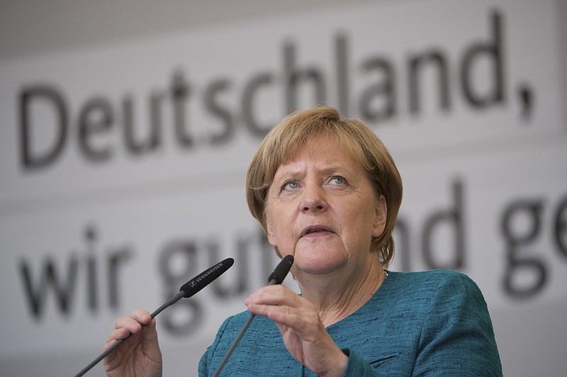 
              In this Aug. 17, 2017 file photo,  German Chancellor Angela Merkel speaks during an election campaign event in Annaberg-Buchholz, eastern Germany. German Chancellor Angela Merkel on Sunday Aug. 20, 2017 stood by her decision to open Germany's borders to hundreds of thousands of refugees two years ago, a move she has previously defended as a necessary response to a humanitarian emergency. Asked during a pre-election television event with voters whether she would do things differently if faced with the same situation, Merkel said in retrospect, "I still think my decision was right."  (Sebastian Kahnert/dpa via AP)
            