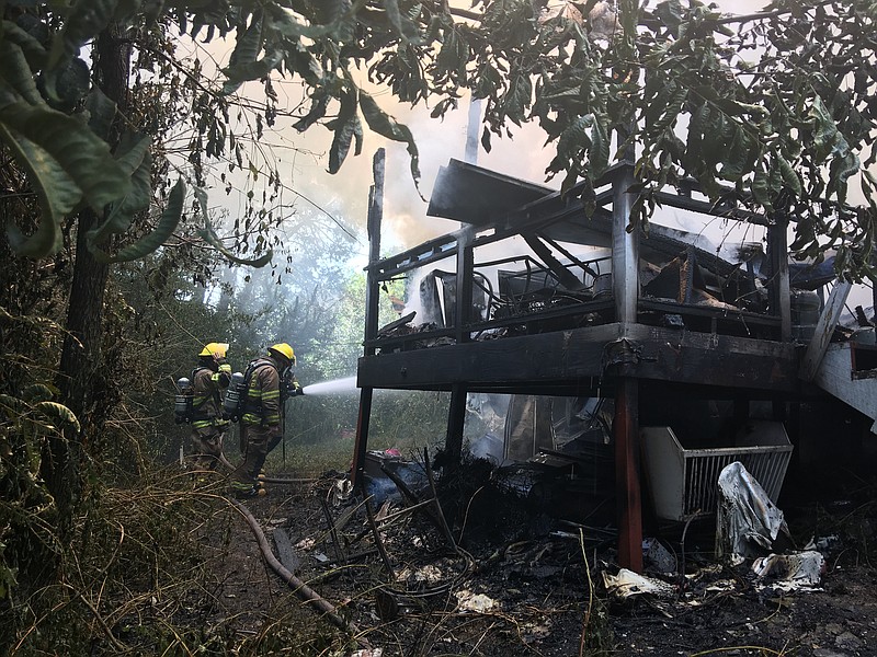 Firefighters work to contain a mobile home fire on Monday, August 21, 2017 on Ogrady Drive.