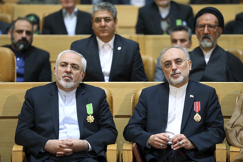 
              FILE-- In this file photo taken on Monday, Feb. 8, 2016, chief of Iran's Atomic Energy Organization Ali Akbar Salehi, right, sits next to Foreign Minister Mohammad Javad Zarif after being awarded medal of honor by President Hassan Rouhani during a ceremony in Tehran, Iran. Iran's atomic chief warned Tuesday the Islamic Republic needs only five days to ramp up its uranium enrichment to 20 percent, a level at which the material could be used for a nuclear weapon. (AP Photo/Ebrahim Noroozi, File)
            