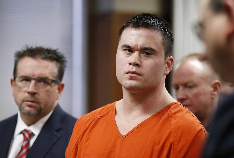 
              FILE - In this Jan. 21, 2016, file photo, former Oklahoma City police officer Daniel Holtzclaw, center, and his attorney Scott Adams are seen at a sentencing hearing in Oklahoma City. Holtzclaw's conviction and 263-year prison sentence for rape and other sex crimes are coming under increased scrutiny as questions are raised about DNA evidence amid a series of sealed court filings and secret hearings. Holtzclaw is appealing the conviction. (AP Photo/Sue Ogrocki, Pool, File)
            