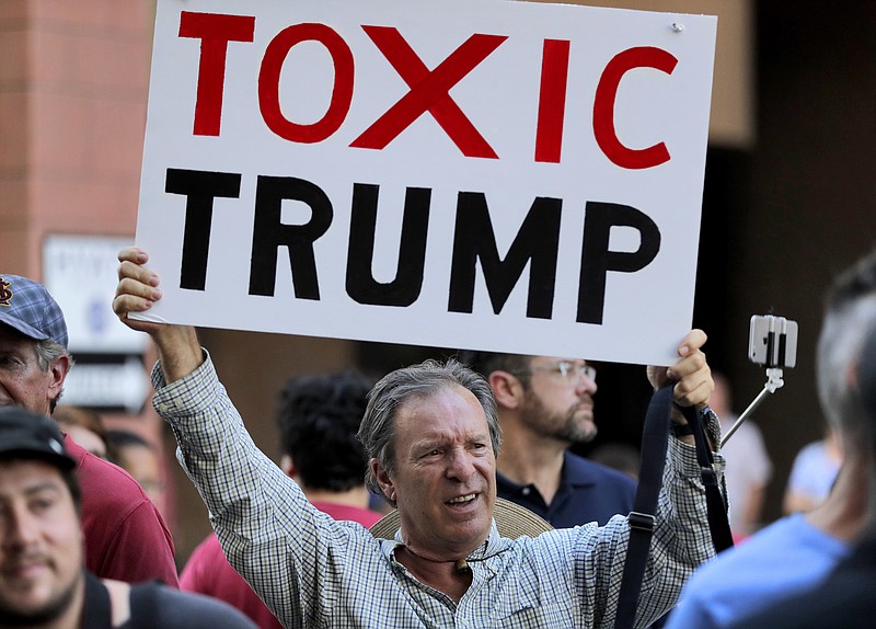 People protest outside the Phoenix Convention Center, Tuesday, Aug. 22, 2017, in Phoenix. Protests were held against President Donald Trump as planned to host a rally inside the convention center. (AP Photo/Matt York)