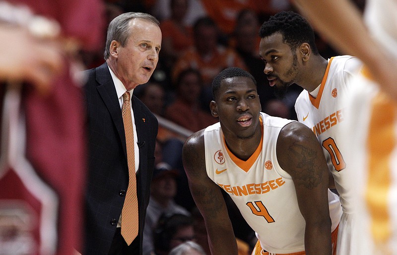 Tennessee head coach Rick Barnes talks with forward Armani Moore (4) and guard Kevin Punter (0) during the second half of an NCAA college basketball game against South Carolina Saturday, Jan. 23, 2016, in Knoxville, Tenn. Tennessee won 78-69. (AP Photo/Wade Payne)