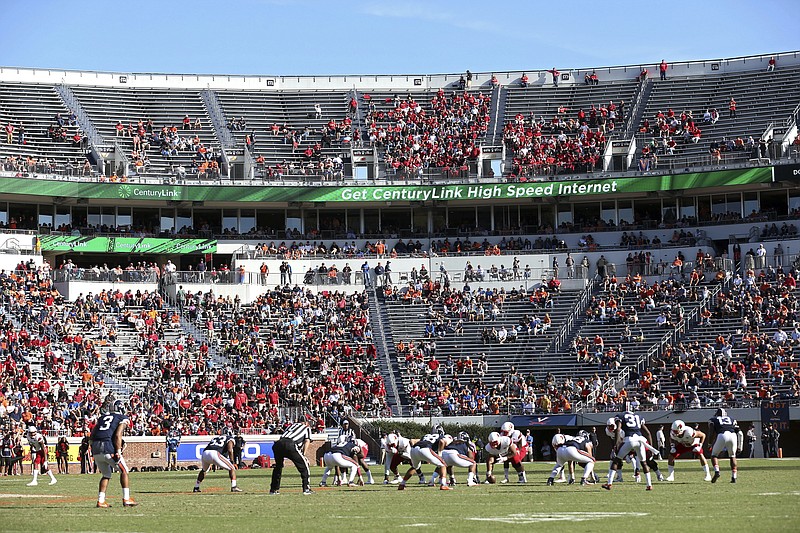 In this Oct. 29, 2016, file photo, Louisville lines up for a play against Virginia during an NCAA college football game in Charlottesville, Va. ESPN broadcaster Robert Lee didn't work Virginia's season opener because of recent violence in Charlottesville sparked by the decision to remove a statue of Confederate Gen. Robert E. Lee. The network said the decision was made "as the tragic events in Charlottesville were unfolding, simply because of the coincidence of his name." (AP Photo/Ryan M. Kelly, File)
            