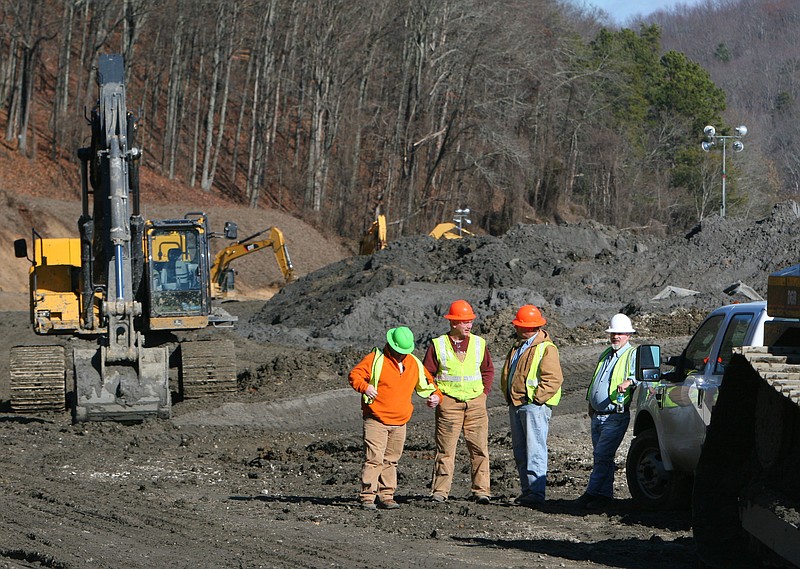 Unidentified workers take a break from relocating coal fly ash while at the coal-fired TVA Kingston Fossil Fuel Power Plant near a breached earthen dike which released over 1 billion gallons of fly ash and coal-burning residues into the Emory River on Dec. 22, 2008.