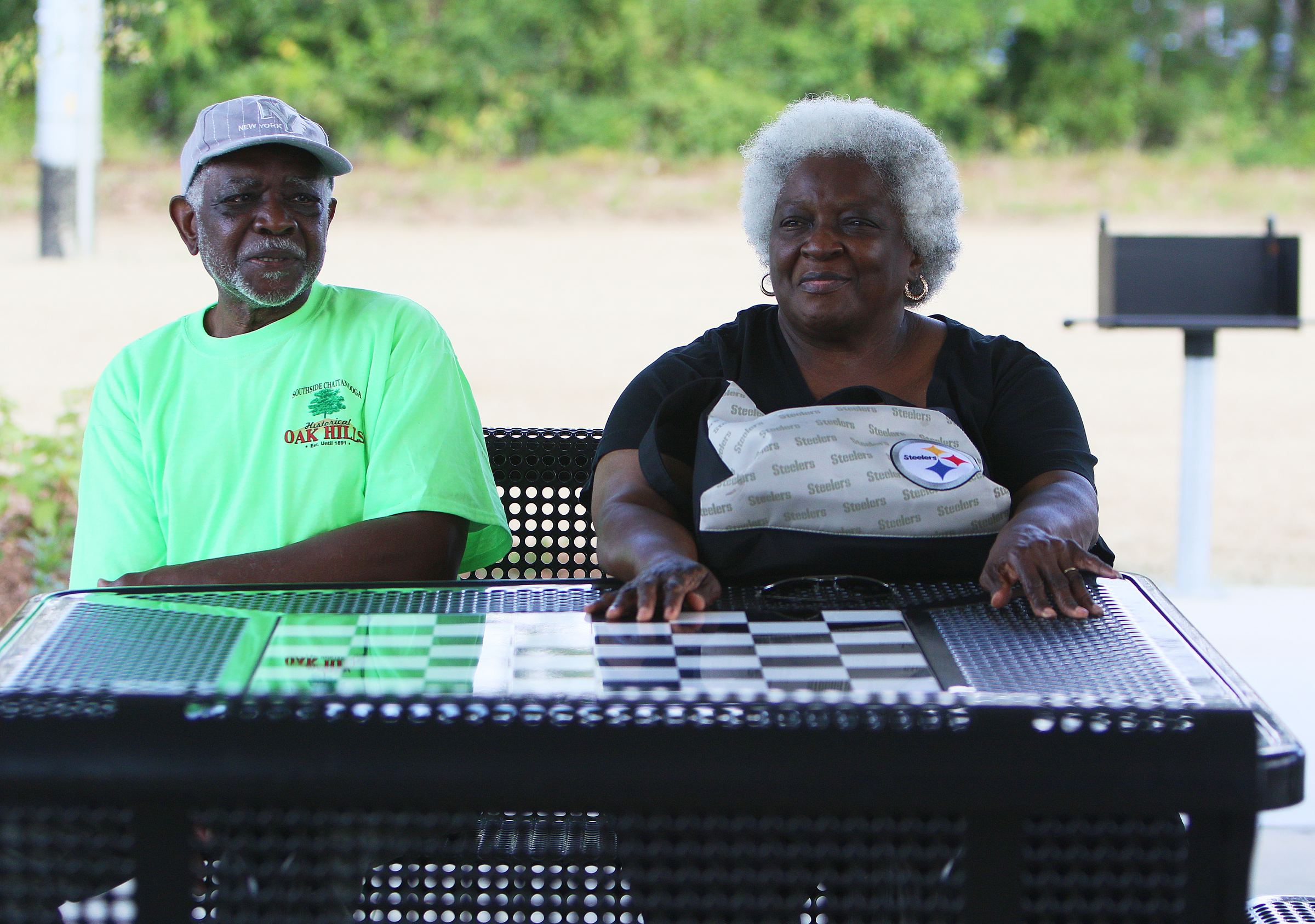 Nathaniel Williams and Donna Macon sit at one of the newly installed tables Wednesday, Aug. 23, 2017, during the ribbon cutting ceremony for the Southside Community Park in Chattanooga, Tenn. Williams is a captain in the Oak Hills Community and Macon lives near the new park.