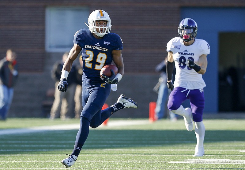 UTC defensive back Lucas Webb returns an intercepted football ahead of Weber State tight end Helam Heimuli during the Mocs' first-round FCS football playoff game against Weber State at Finely Stadium on Saturday, Nov. 26, 2016, in Chattanooga, Tenn. UTC won 45-14.