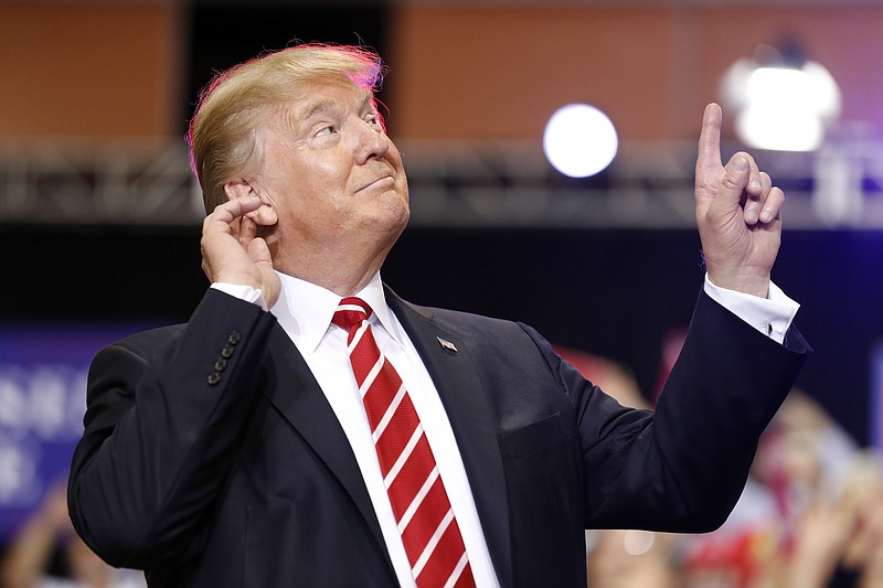 
              President Donald Trump reacts to the song as he arrives at a rally at the Phoenix Convention Center, Tuesday, Aug. 22, 2017, in Phoenix. (AP Photo/Alex Brandon)
            