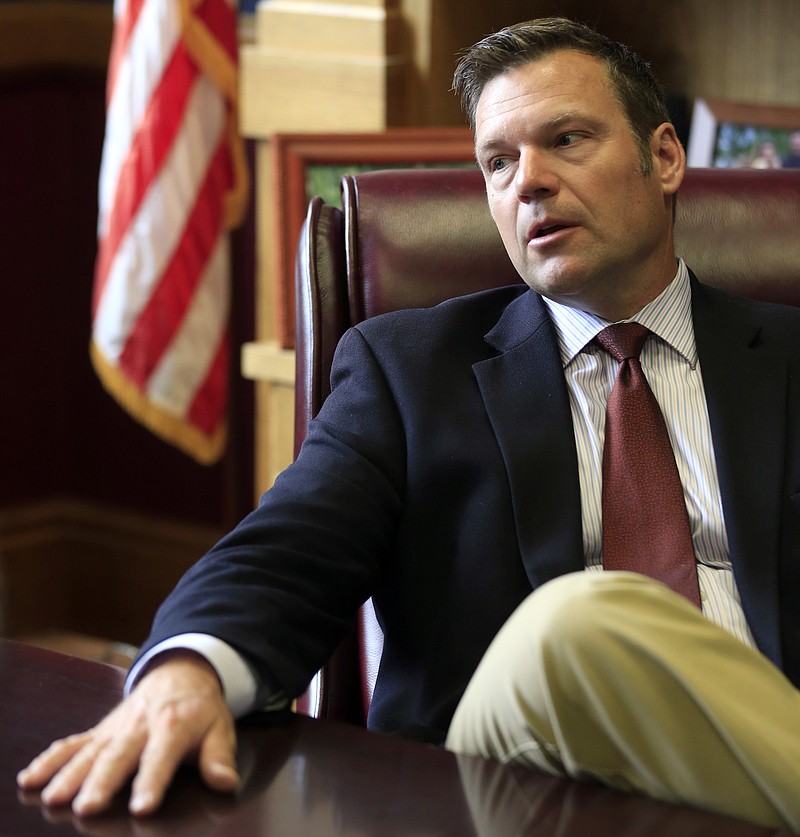 
              FILE - In this May 17, 2017, file photo, Kansas Secretary of State Kris Kobach talks with a reporter in his office in Topeka. Kobach, co-chairman of President Donald Trump's Presidential Advisory Commission on Election Integrity who is promoting Trump's unsubstantiated claims of widespread voter fraud, oversees a Kansas election system that threw out at least three times as many ballots as similarly sized states did. That is fueling concerns about massive voter suppression should its practices become the national standard. (AP Photo/Orlin Wagner, File)
            