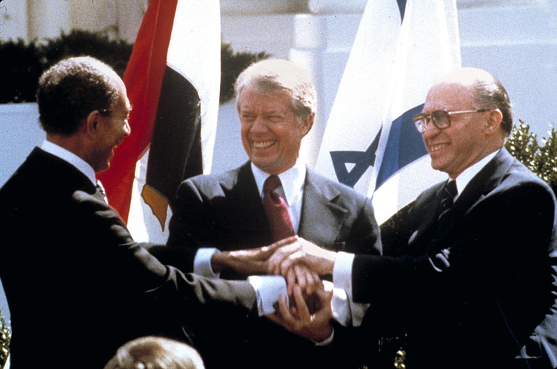 
              FILE - In this March 26, 1979 file photo, Egyptian President Anwar Sadat, left, U.S. President Jimmy Carter, center, and Israeli Prime Minister Menachem Begin clasp hands on the North Lawn of the White House as they completed signing of the peace treaty between Egypt and Israel. Washington’s surprise decision on Tuesday, Aug. 22, 2017, to cut or delay nearly $300 million in aid to Egypt is the first time the Trump administration has publicly called out Cairo on its poor human rights record. It was also the latest twist in a decades-old relationship marked by dependence and disappointment on both sides. (AP Photo/Bob Daugherty, File)
            