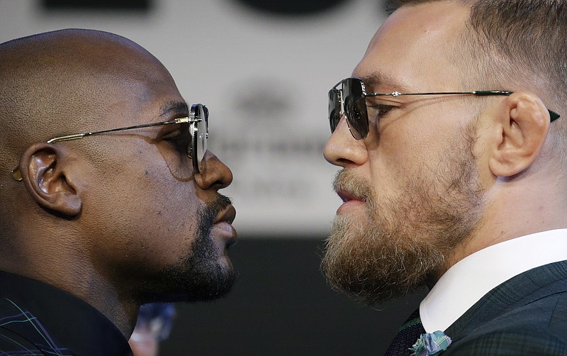 
              Floyd Mayweather Jr., left, and Conor McGregor pose for photographers during a news conference Wednesday, Aug. 23, 2017, in Las Vegas. The two are scheduled to fight in a boxing match Saturday in Las Vegas. (AP Photo/John Locher)
            