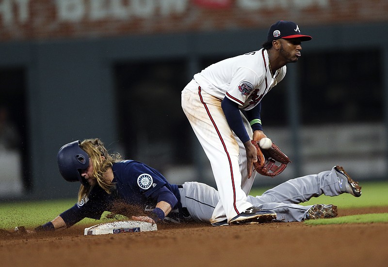 Seattle Mariners' Taylor Motter (21) steals seconds base as Atlanta Braves second baseman Ozzie Albies (1) handles the late throw in the eighth inning of a baseball game Wednesday, Aug. 23, 2017, in Atlanta. (AP Photo/John Bazemore)