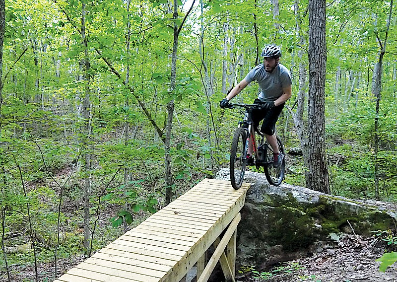 A mountain biker crosses one of the wooden bridges near the newly developed Chattanooga Connector Trail.