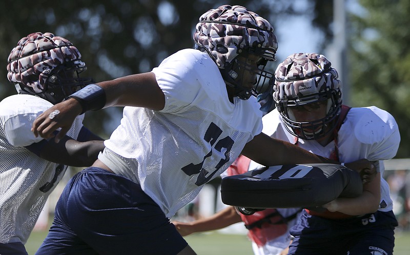 Chattanooga Christian's Keano Roberts (73) blocks during practice at David Stanton Field on the campus of Chattanooga Christian School on Thursday, Aug. 24, in Chattanooga, Tenn. Roberts is an exchange student from The Bahamas.