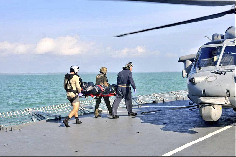 
              In this photo released by the Royal Malaysian Navy, an unidentified body recovered by the Royal Malaysian Navy is 
transferred to a U.S. Navy helicopter off the Johor coast of Malaysia, Wednesday, Aug. 23, 2017. The commander of the Navy's 7th Fleet will be removed after a series of warship accidents in the Pacific this year, two U.S. officials said Wednesday. (Royal Malaysian Navy via AP)
            