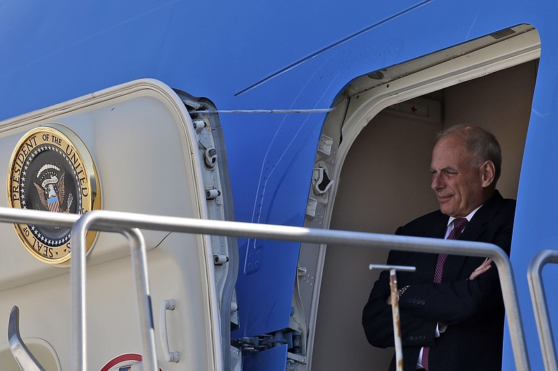 
              White House Chief of Staff John Kelly stands in the door of Air Force One and watches President Donald Trump, as he arrives Wednesday, Aug. 23, 2017, in Reno, Nev. (AP Photo/Alex Brandon)
            