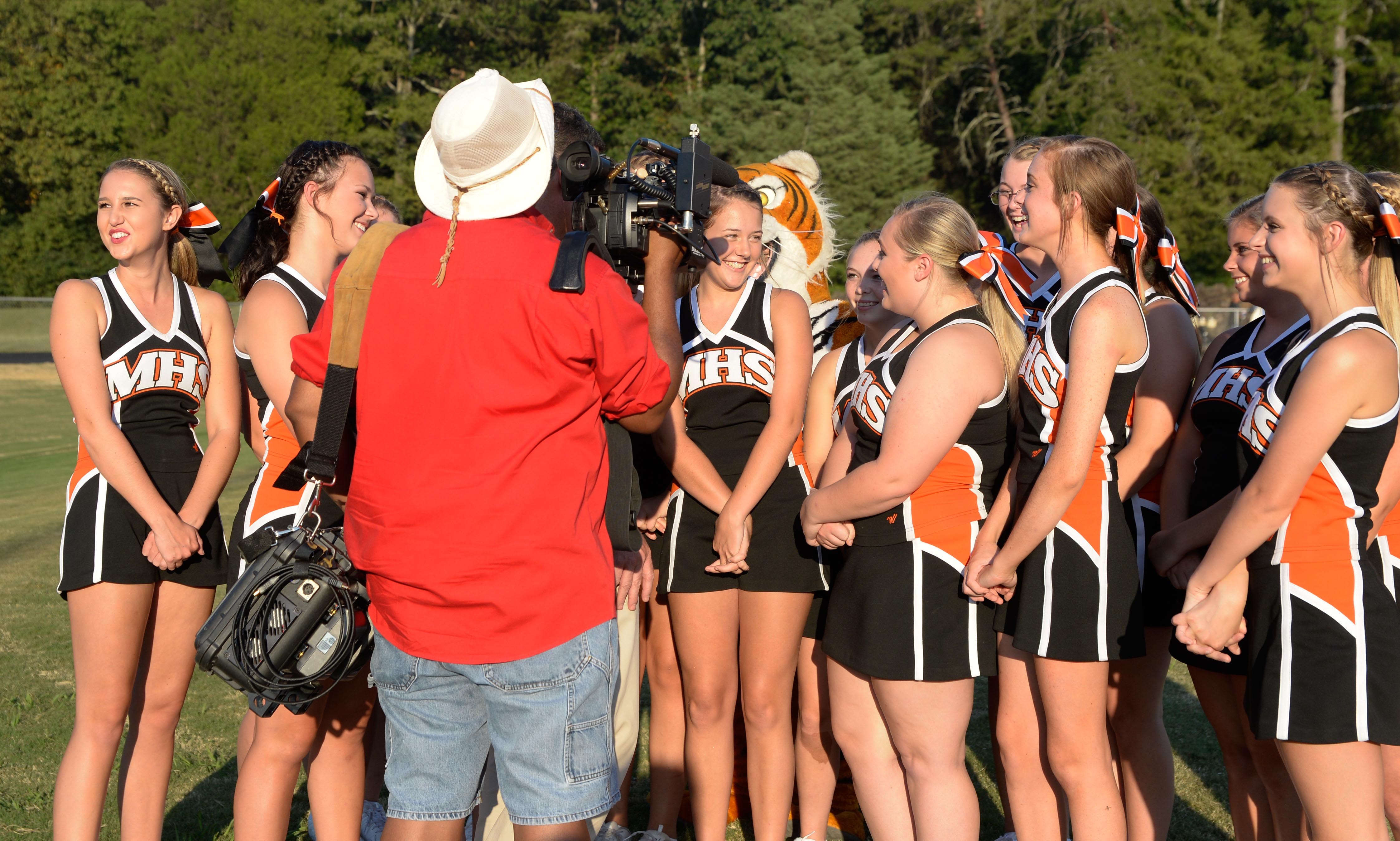(Photo by Mark Gilliland) Meigs County cheerleaders share a laugh for the tv cameras before the game against Hixson. Meigs County faced Hixson August 25, 2017.