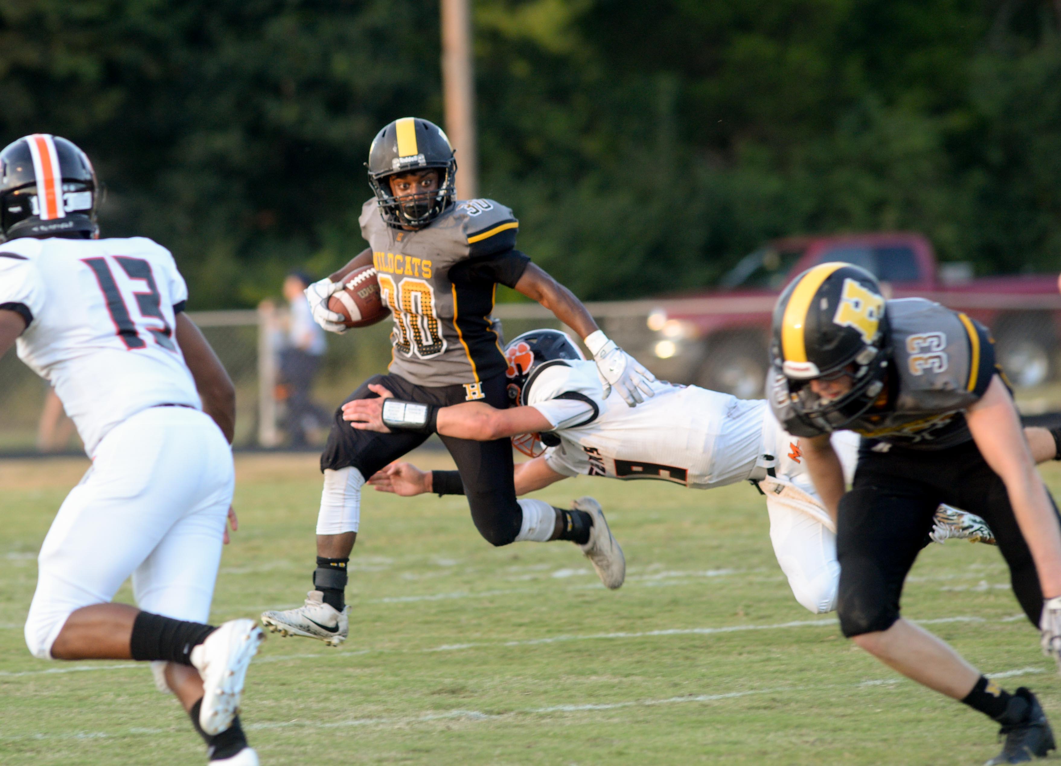 (Photo by Mark Gilliland) Hixson's Josiah Bowman tries to avoid a tackle by Meig's County Aaron Swafford during the game on August 25, 2017.