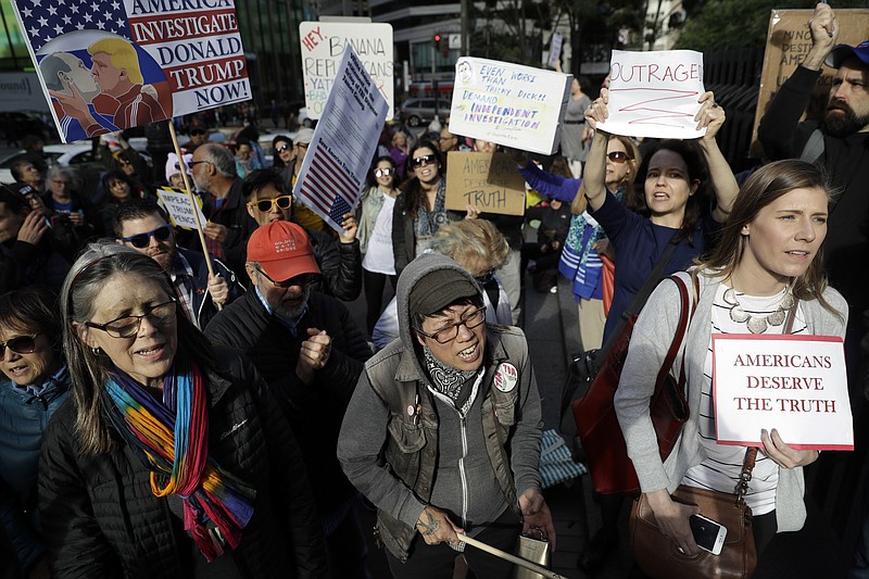 
              File - In this May 10, 2017, file photo, protesters stage outside of the offices of Sen. Dianne Feinstein in San Francisco. Northern California police and civic leaders are hoping for calm, but bracing for violence this weekend when hundreds, possibly thousands, of demonstrators of all stripes flock to the San Francisco Bay Area for dueling political rallies. Law enforcement officials in San Francisco and Berkeley, California are grappling with protecting free speech rights while preventing the type of violence that occurred this month in Charlottesville, Va.  (AP Photo/Marcio Jose Sanchez, File)
            