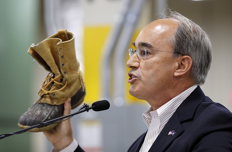 
              FILE - In this Aug. 17, 2017 file photo, U.S. Rep. Bruce Poliquin, R-Maine, holds his personal L.L. Bean boot while speaking at an event at the new L.L. Bean manufacturing center in Lewiston, Maine. Poliquin is boasting about his skills in avoiding the press.
The 2nd District Republican told a group behind closed doors in Bangor this week he deliberately avoids the press because “as soon as you go down that path, you are in the swamp.” (AP Photo/Robert F. Bukaty)
            