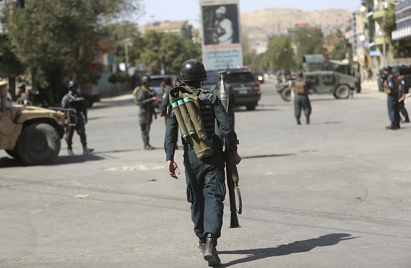 
              Policemen walk near the site of an ongoing attack on a Shiite mosque in Kabul, Afghanistan, Friday, Aug. 25, 2017. Gunmen stormed a Shiite mosque in the Afghan capital while worshippers were at Friday prayers, setting off an explosion that killed a security guard outside and pushing into the shrine, officials said. (AP Photo/Massoud Hossaini)
            