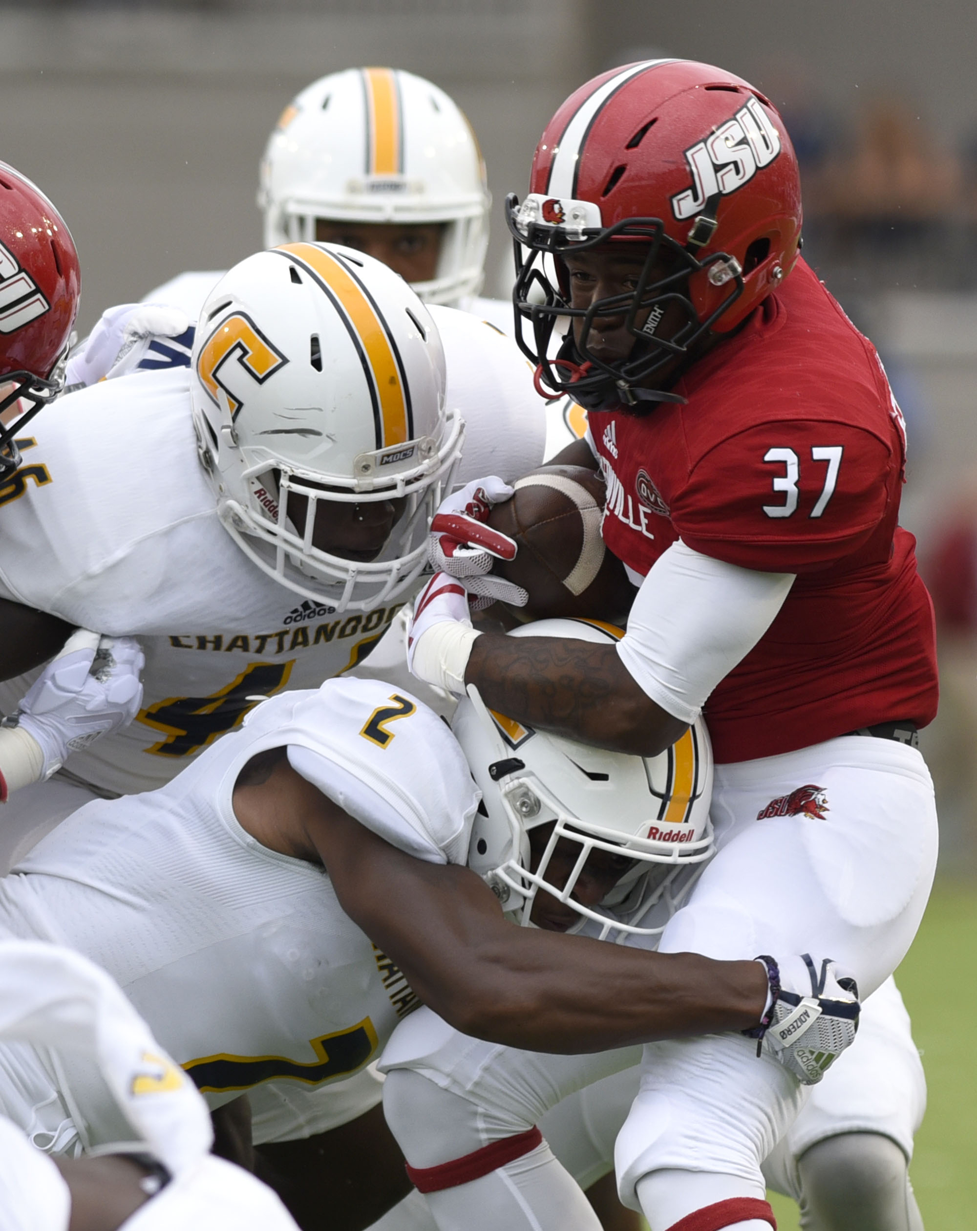UTC's Kareem Orr (2) and T.J. Jenkins (46) stop Jacksonville's De'Marcus Flowers (37). The University of Chattanooga Mocs met the Jacksonville State Gamecocks in the Guardian Credit Union FCS Kickoff at the Carmton Bowl in Montgomery, Alabama on August 26, 2017.