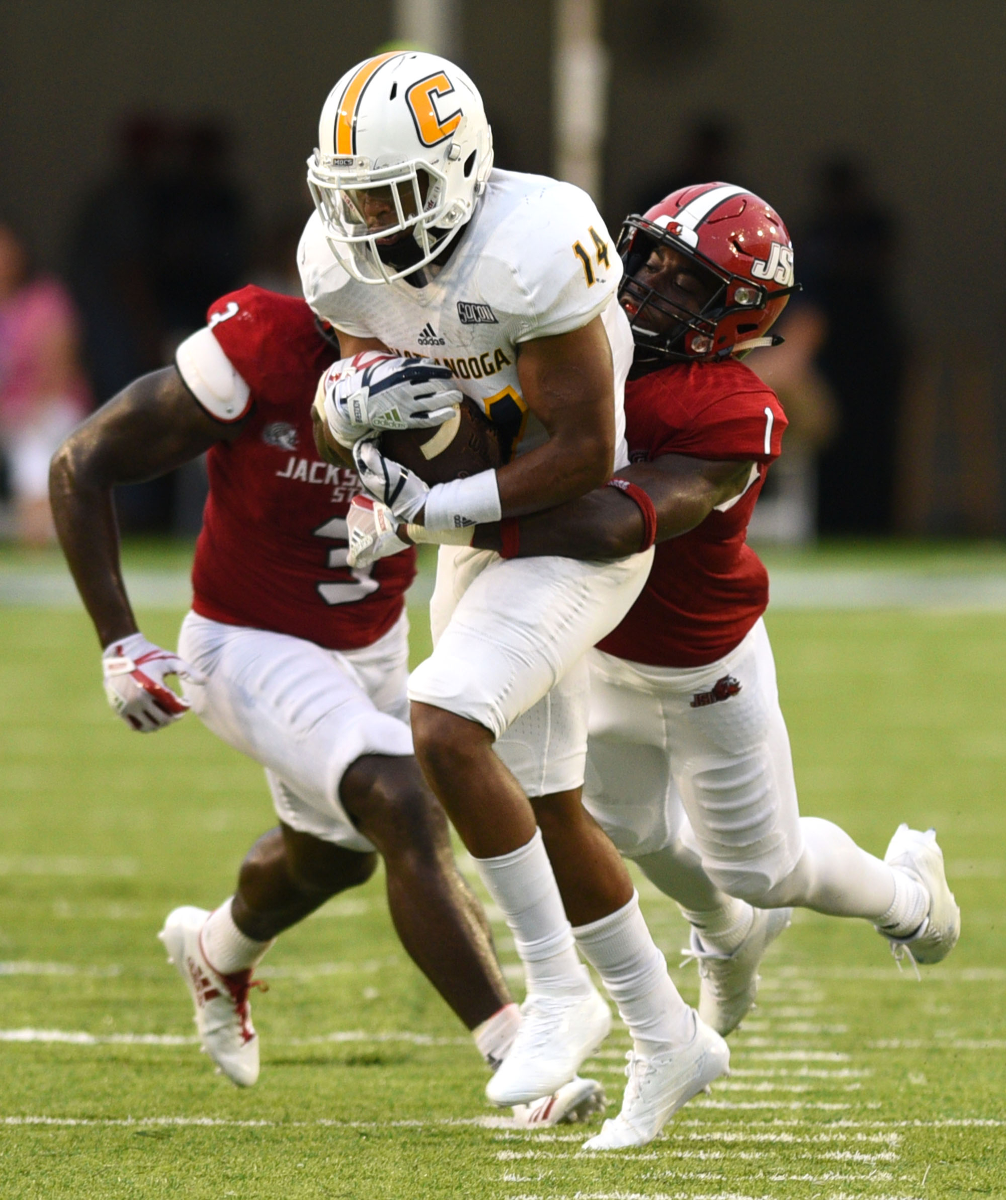UTC's Darrell Bridges (14) is dragged down by Jacksonville's Marion Bridges (1) after a pass reception. The University of Chattanooga Mocs met the Jacksonville State Gamecocks in the Guardian Credit Union FCS Kickoff at the Carmton Bowl in Montgomery, Alabama on August 26, 2017.