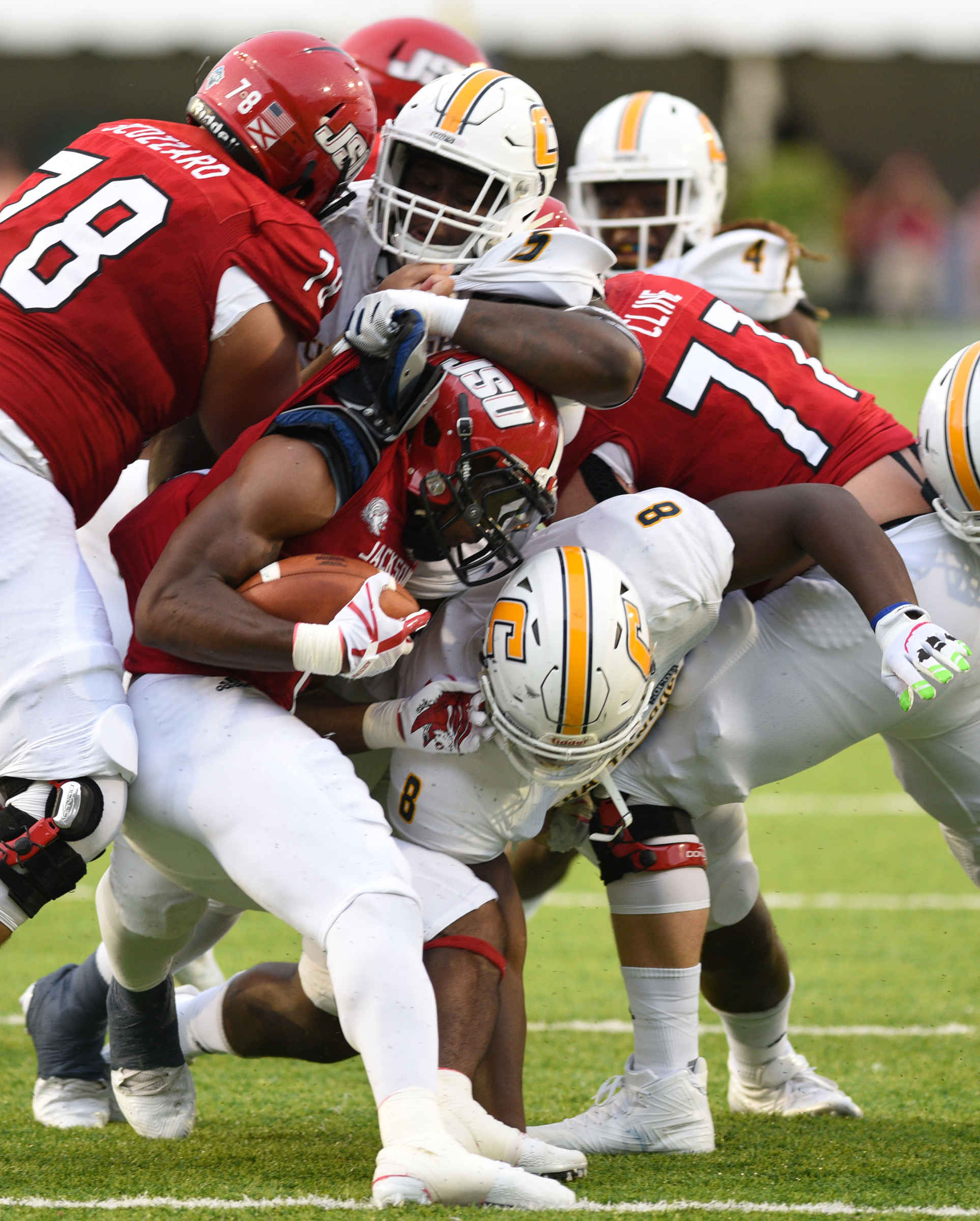 UTC's Derek Mahaffey (5) and Isaiah Mack (8) bring down Jacksonville's Roc Thomas (6). The University of Chattanooga Mocs met the Jacksonville State Gamecocks in the Guardian Credit Union FCS Kickoff at the Carmton Bowl in Montgomery, Alabama on August 26, 2017.