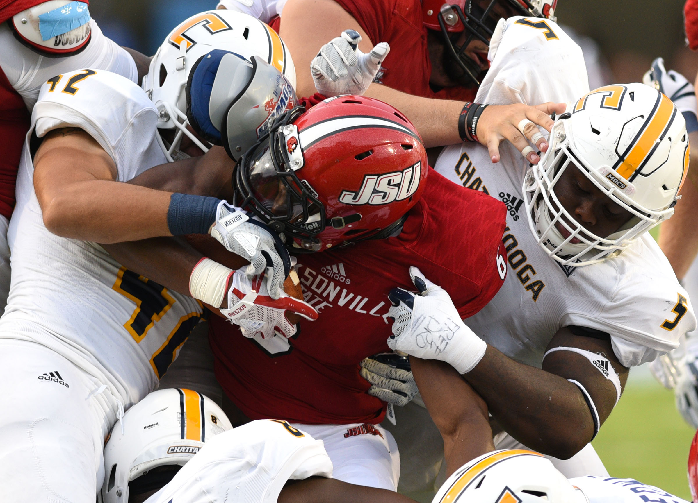 UTC's Hawk Schrider (42), Derek Mahaffey (5) and Isaiah Mack (8) make a brutal tackle on Jacksonville's Roc Thomas (6). The University of Chattanooga Mocs met the Jacksonville State Gamecocks in the Guardian Credit Union FCS Kickoff at the Carmton Bowl in Montgomery, Alabama on August 26, 2017.