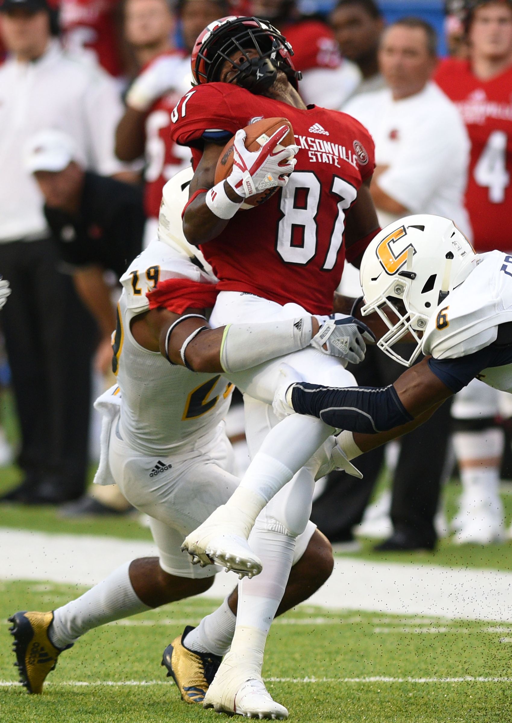 Jacksonville's Demontez Terry (87) recoils from a tackle by UTC's Lucas Webb (29) with help from C.J. Fritz (6). The University of Chattanooga Mocs met the Jacksonville State Gamecocks in the Guardian Credit Union FCS Kickoff at the Carmton Bowl in Montgomery, Alabama on August 26, 2017.