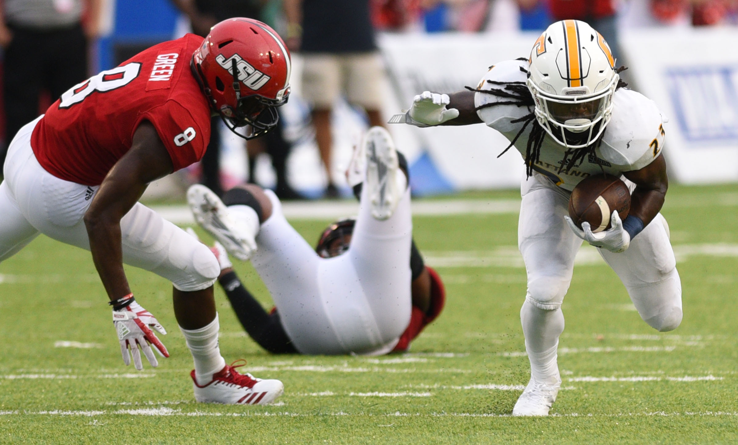 UTC's Richardre Bagley (23) gains yards after a reception. Defending is Jacksonville's Ra'Shad Green (8). The University of Chattanooga Mocs met the Jacksonville State Gamecocks in the Guardian Credit Union FCS Kickoff at the Carmton Bowl in Montgomery, Alabama on August 26, 2017.