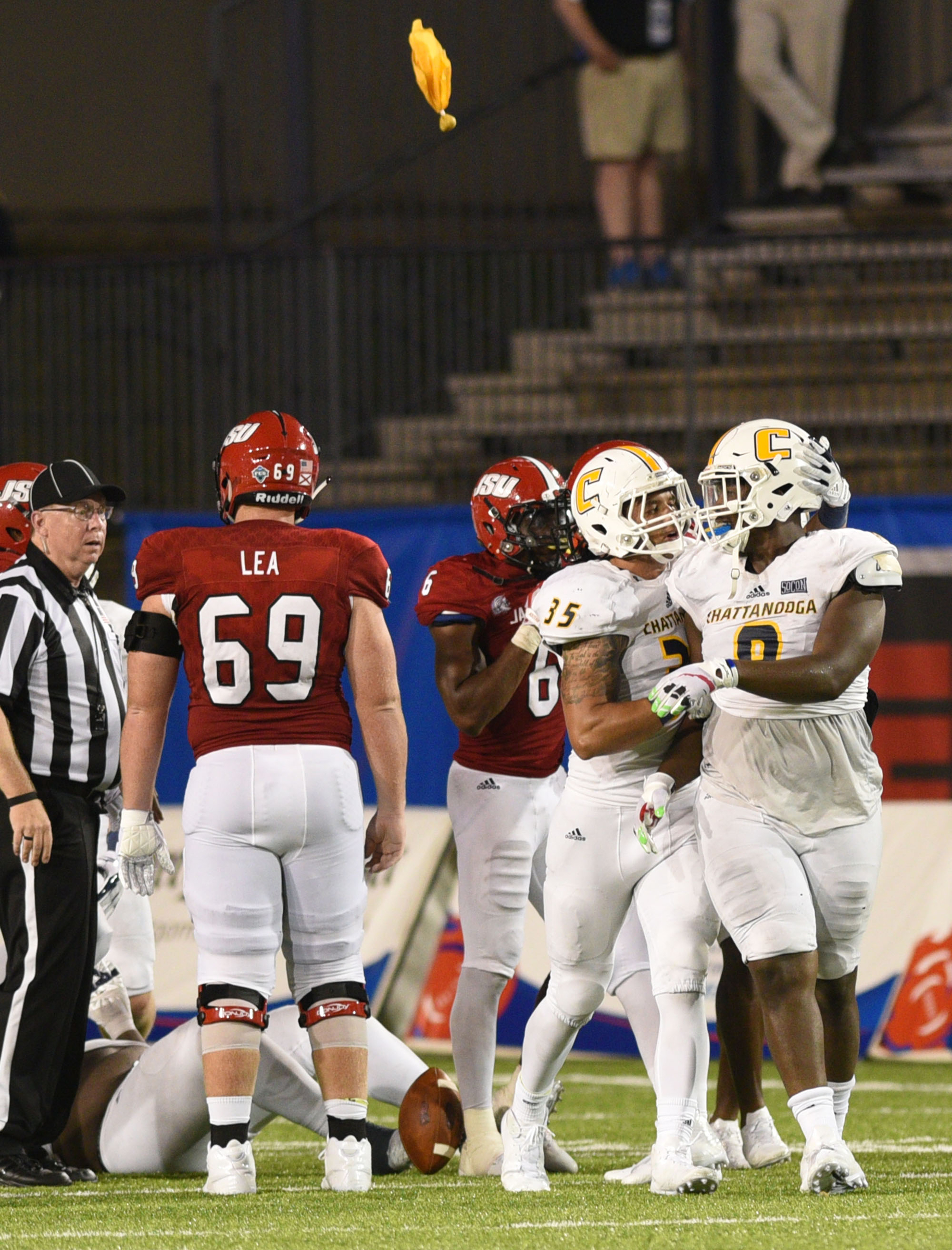 The penatly flag flies as UTC's Isaiah Mack (8), who is consoled by Michael Bean (35) is called for a personal foul. The University of Chattanooga Mocs met the Jacksonville State Gamecocks in the Guardian Credit Union FCS Kickoff at the Carmton Bowl in Montgomery, Alabama on August 26, 2017.