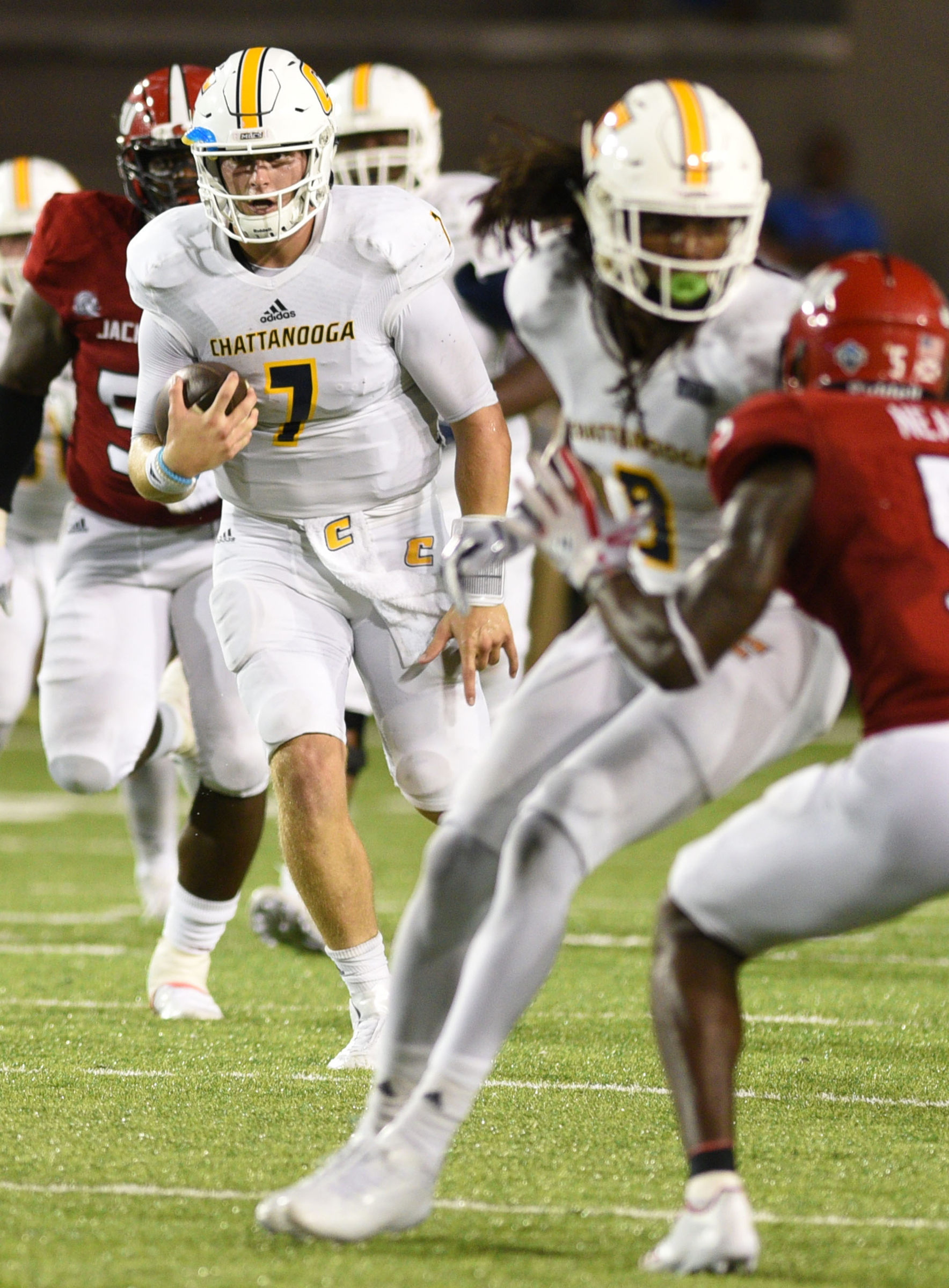 UTC quarterback Nick Tiano (7) runs while Alphonso Stewart (9) attempts to block Jacksonville's Siran Neal (5). The University of Chattanooga Mocs met the Jacksonville State Gamecocks in the Guardian Credit Union FCS Kickoff at the Carmton Bowl in Montgomery, Alabama on August 26, 2017.