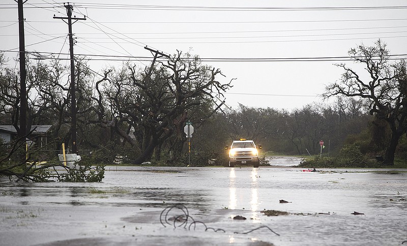 
              A vehicle drives through flooded roads after Hurricane Harvey ripped through Rockport, Texas, on Saturday, Aug. 26, 2017.  The fiercest hurricane to hit the U.S. in more than a decade spun across hundreds of miles of coastline where communities had prepared for life-threatening storm surges — walls of water rushing inland.  (Nick Wanger/Austin American-Statesman via AP)
            